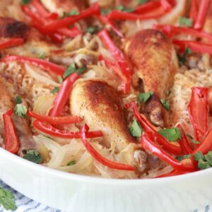 An easy one pan arroz con pollo recipe in a white dish served on a table.