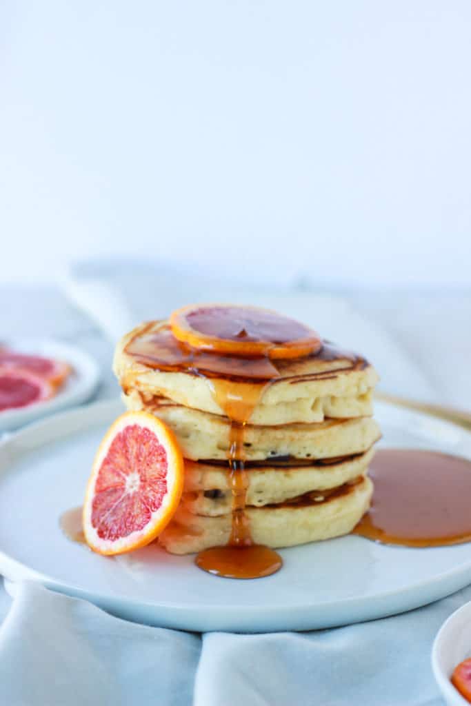 If you're looking for fluffy, easy, stackable, drool worthy pancakes with a hint of citrus, then these are the pancakes for you! #pancakes #bloodorange #fluffy frostingandfettuccine.com