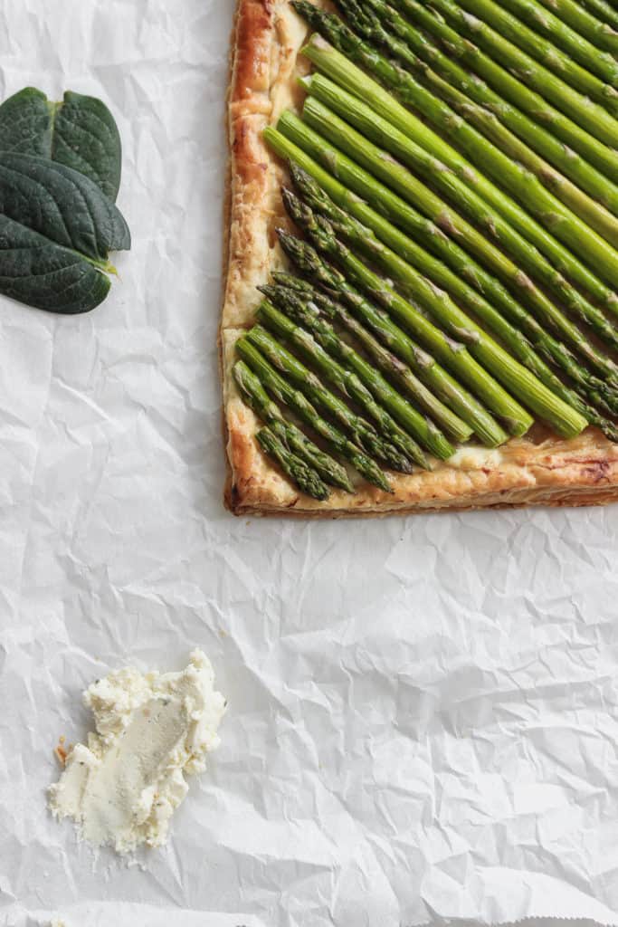 Spring is almost here! Celebrate with this asparagus tart that lays on a bed of caramelized onion and cheese. #drool #spring #asparagustart Frostingandfettuccine.com