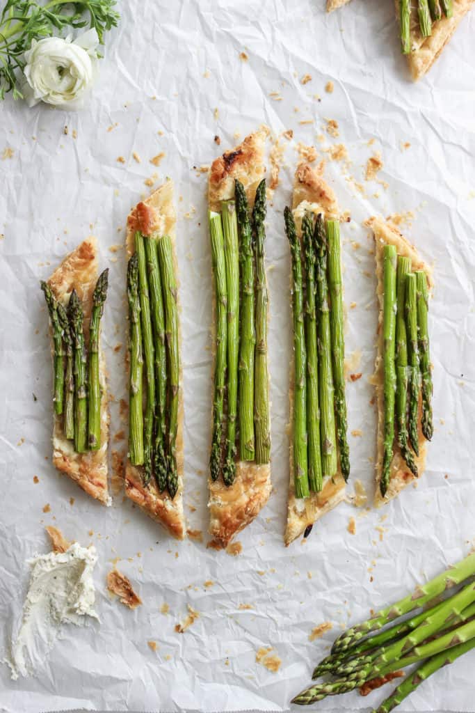 Spring is almost here! Celebrate with this asparagus tart that lays on a bed of caramelized onion and cheese. #drool #spring #asparagustart Frostingandfettuccine.com