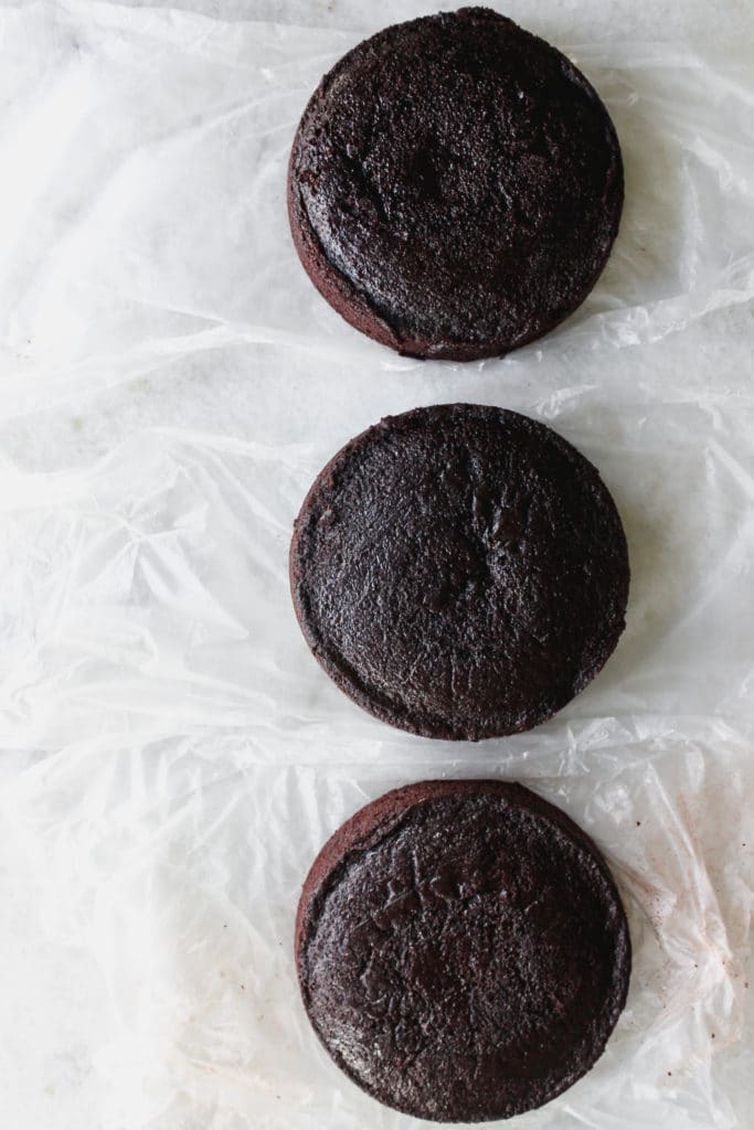 3 chocolate cakes on a white surface