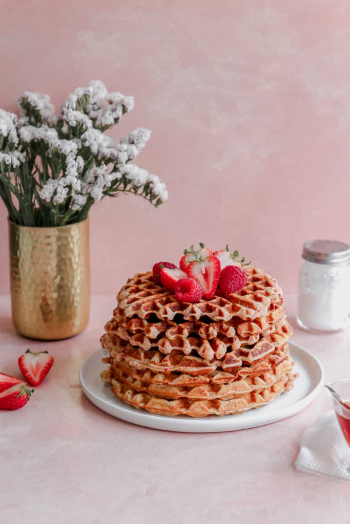 Crispy on the outside, chewy on the inside, these waffles are bursting with strawberry flavor and are a perfect way to treat mom on Mothers Day! #mothersday #breakfastinbed #strawberrywaffles #waffles frostingandfettuccine.com