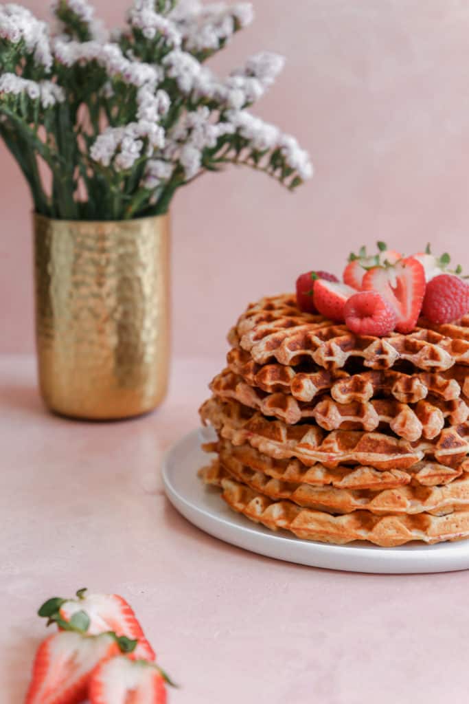 Crispy on the outside, chewy on the inside, these waffles are bursting with strawberry flavor and are a perfect way to treat mom on Mothers Day! #mothersday #breakfastinbed #strawberrywaffles #waffles frostingandfettuccine.com