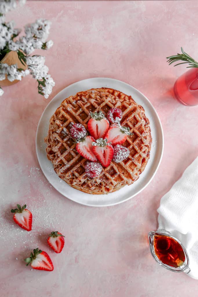 Crispy on the outside, chewy on the inside, these waffles are bursting with strawberry flavor and are a perfect way to treat mom on Mothers Day! #mothersday #breakfastinbed #strawberrywaffles #waffles frostingandfettuccine.com