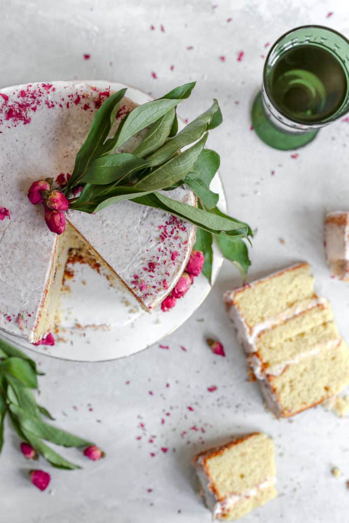 sliced orange cardamom cake garnished with dried rose petals