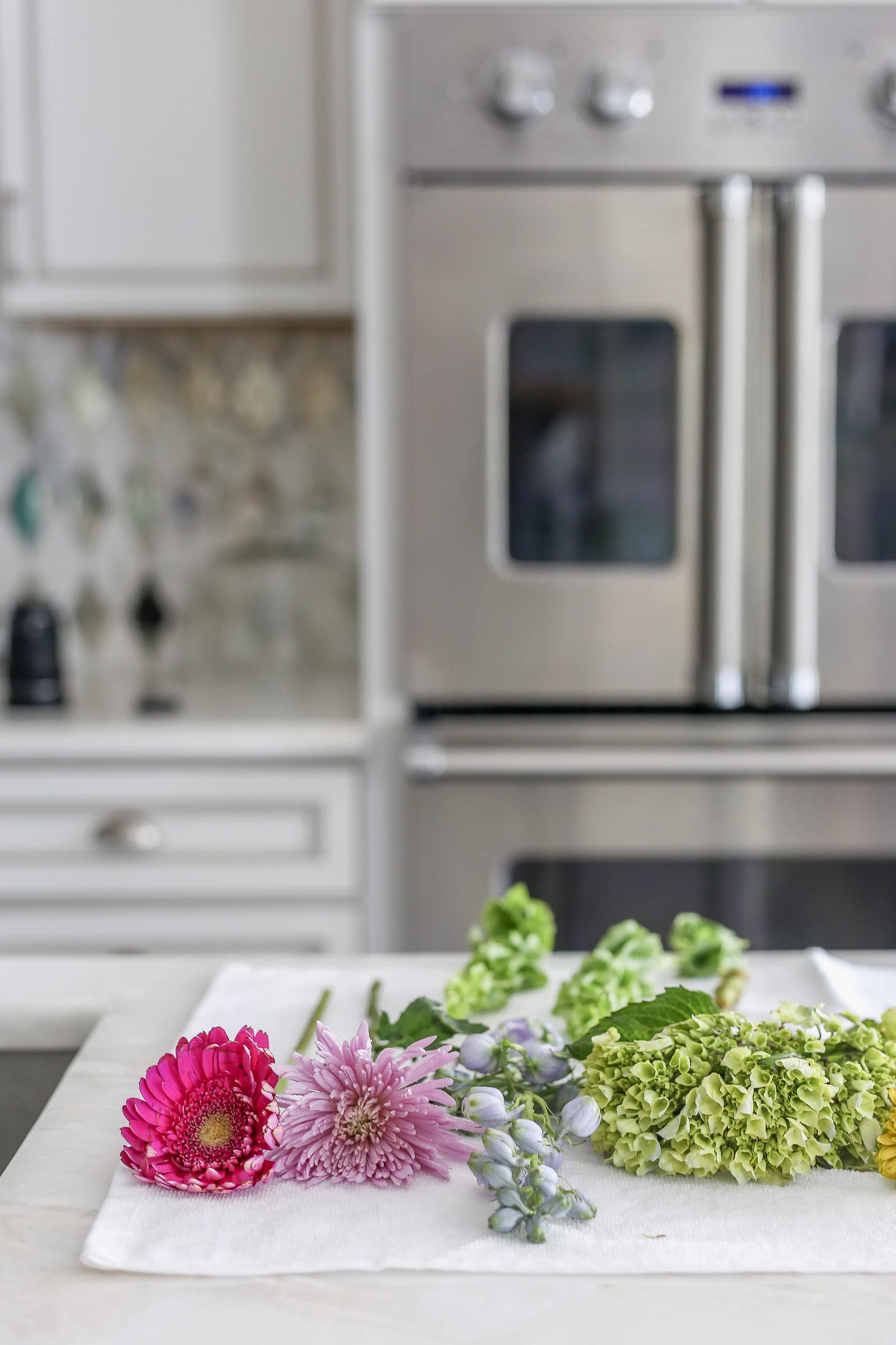 Clean fresh flowers drying on a towel before demonstrating how to decorate a cake with flowers.