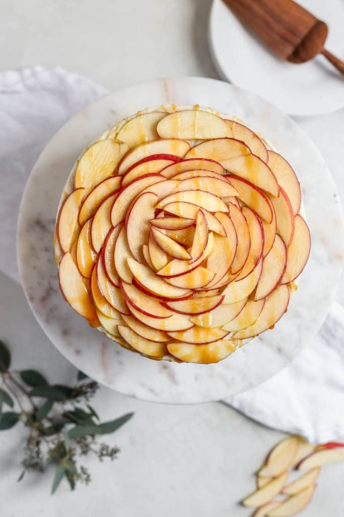 Sliced apples arranged on a cake to look like a giant rose.