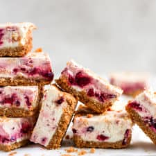 Cranberry cheesecake bars stacked on each other