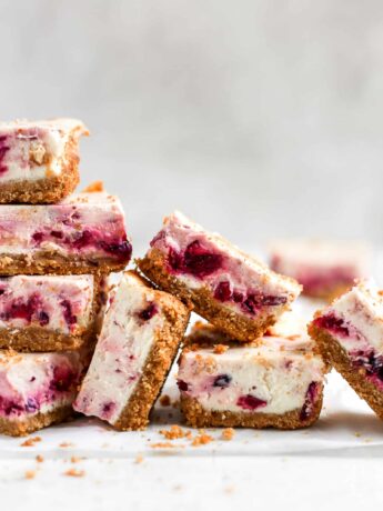 Cranberry cheesecake bars stacked on each other.
