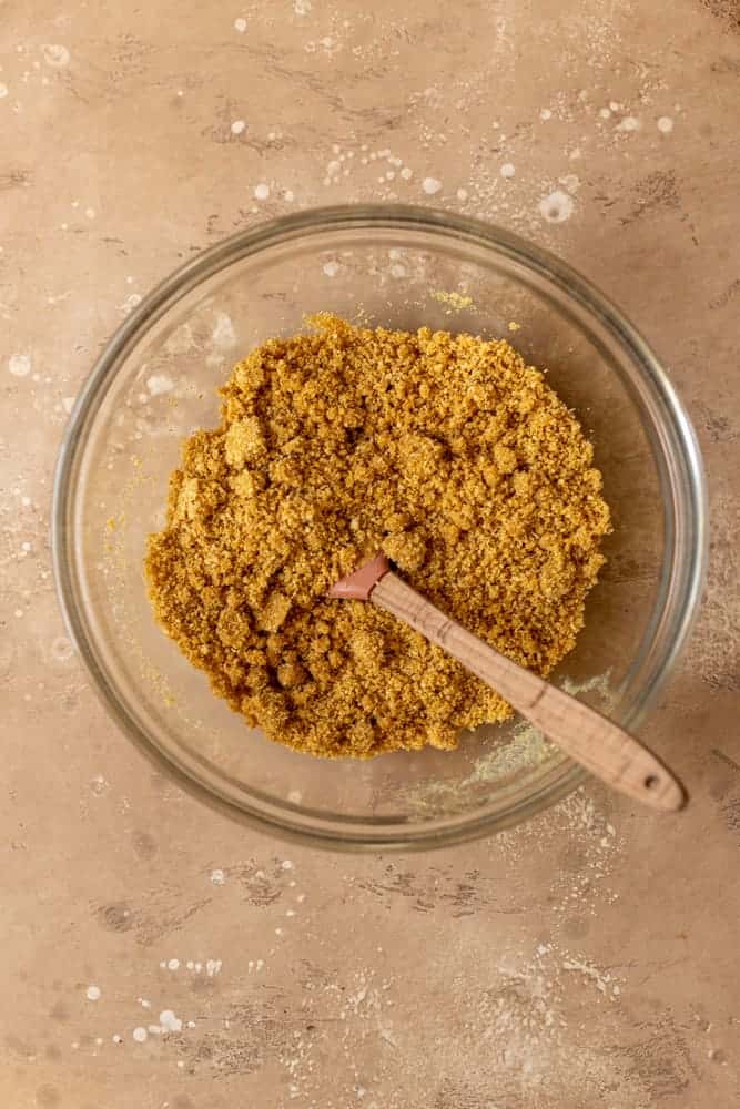 Graham cracker crust ingredients mixed in a bowl.