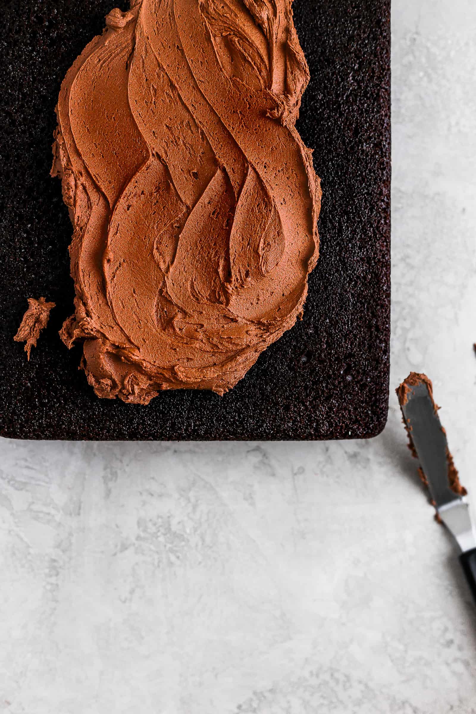 Swirls of chocolate buttercream on a one bowl chocolate cake.