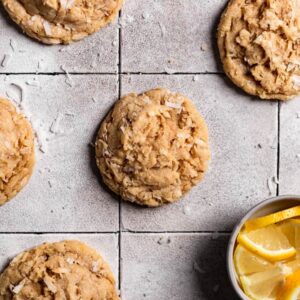Lemon coconut cookies on a gray tiled surface