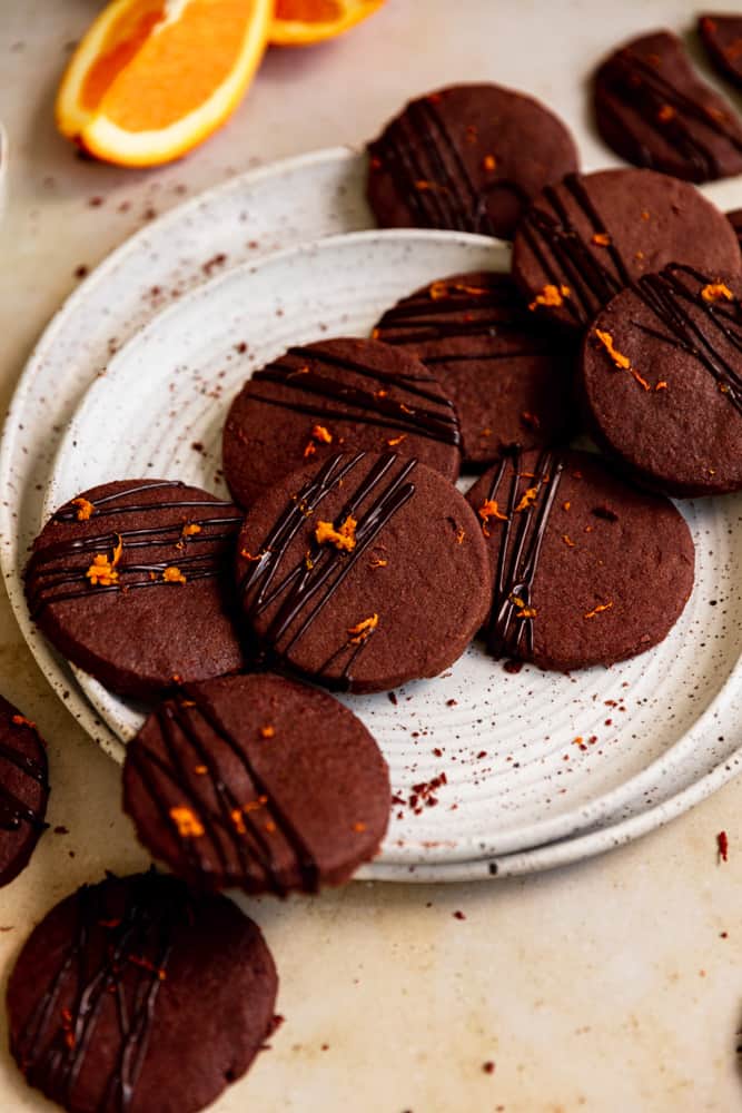 Chocolate cookies on 2 white plates .
