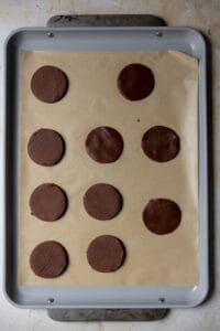 Chocolate cookie dough slices on a sheet tray.