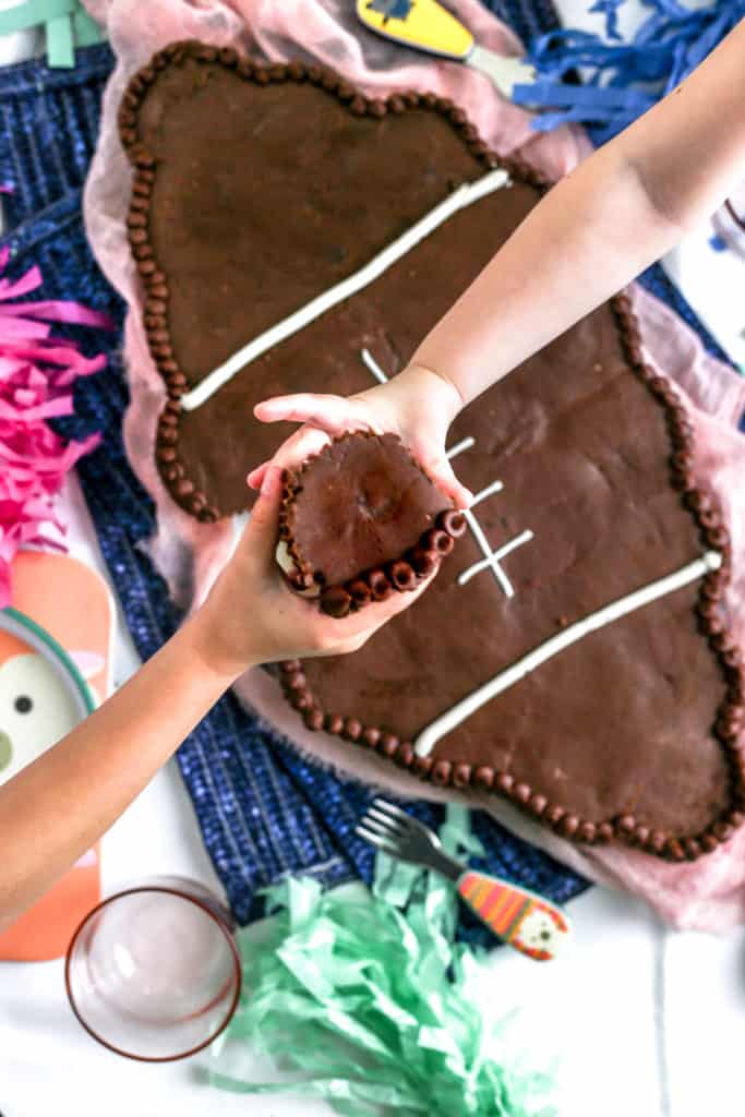 children passing chocolate cupcakes to each other