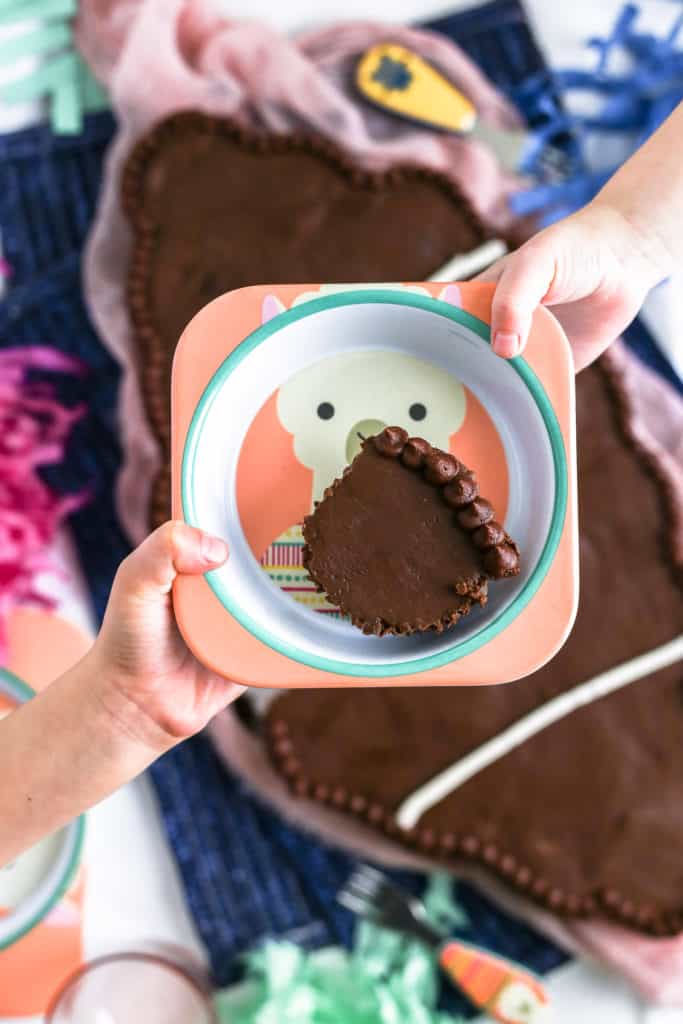 children passing plate of chocolate cupcakes to each other