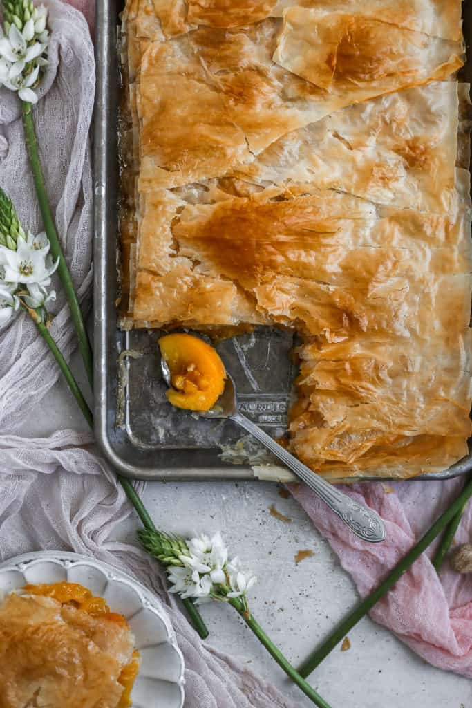  A spoonful of peach slab pie in a sheet tray