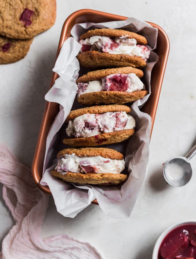 Rhubarb ice cream sandwiches stacked on their side in a loaf pan.