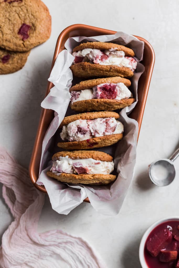 Rhubarb ice cream sandwiches stacked on their side in a loaf pan.