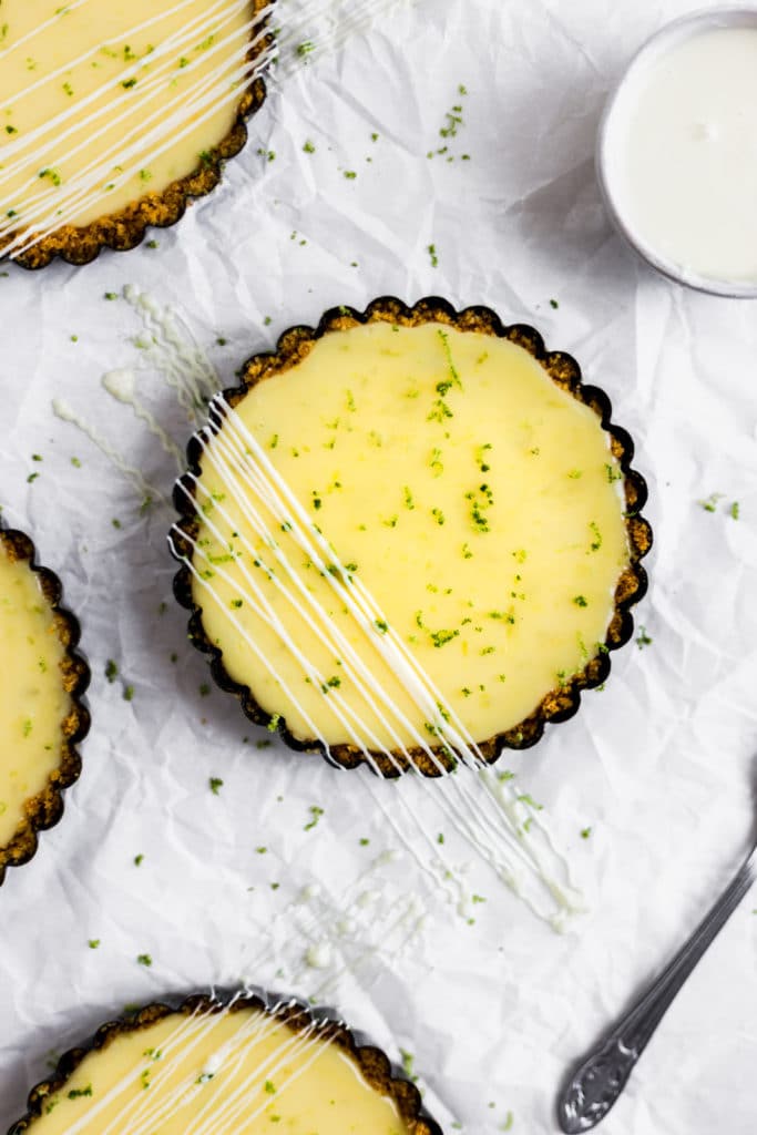 A mini key lime pie drizzled with white chocolate