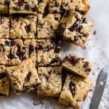 Blondies with chocolate chips cut up and put on its side.
