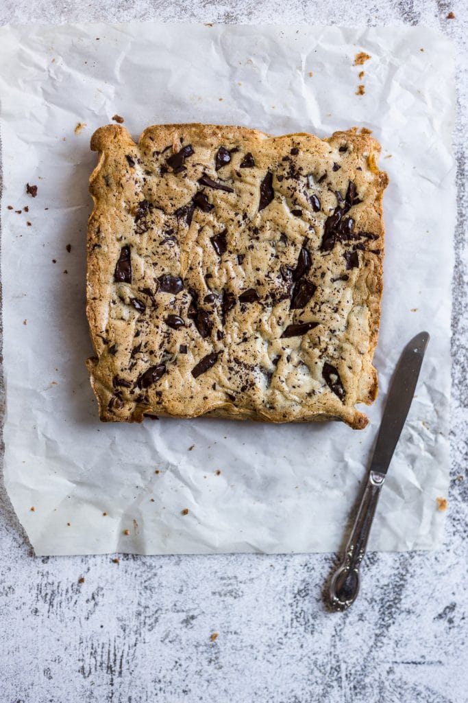 pre cut chocolate chip blondies on a piece of parchment paper.