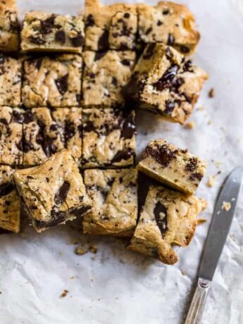 Blondies with chocolate chips cut up and put on its side.