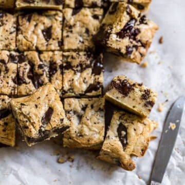 Blondies with chocolate chips cut up and put on its side.