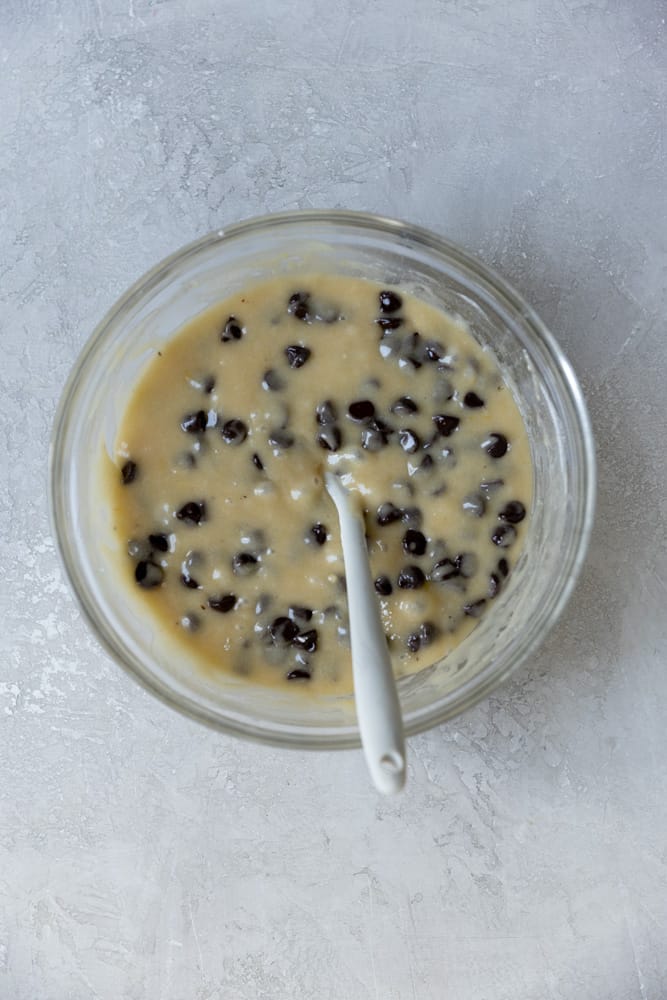Blondie batter with chocolate chips in a glass bowl. 