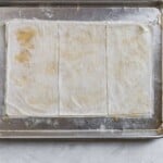 phyllow dough stacks cut into thirds on a sheet tray