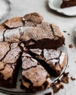 The top of a flourless chocolate cake with 2 slices cut out.