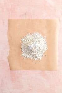 Flour in a pile on brown parchment paper