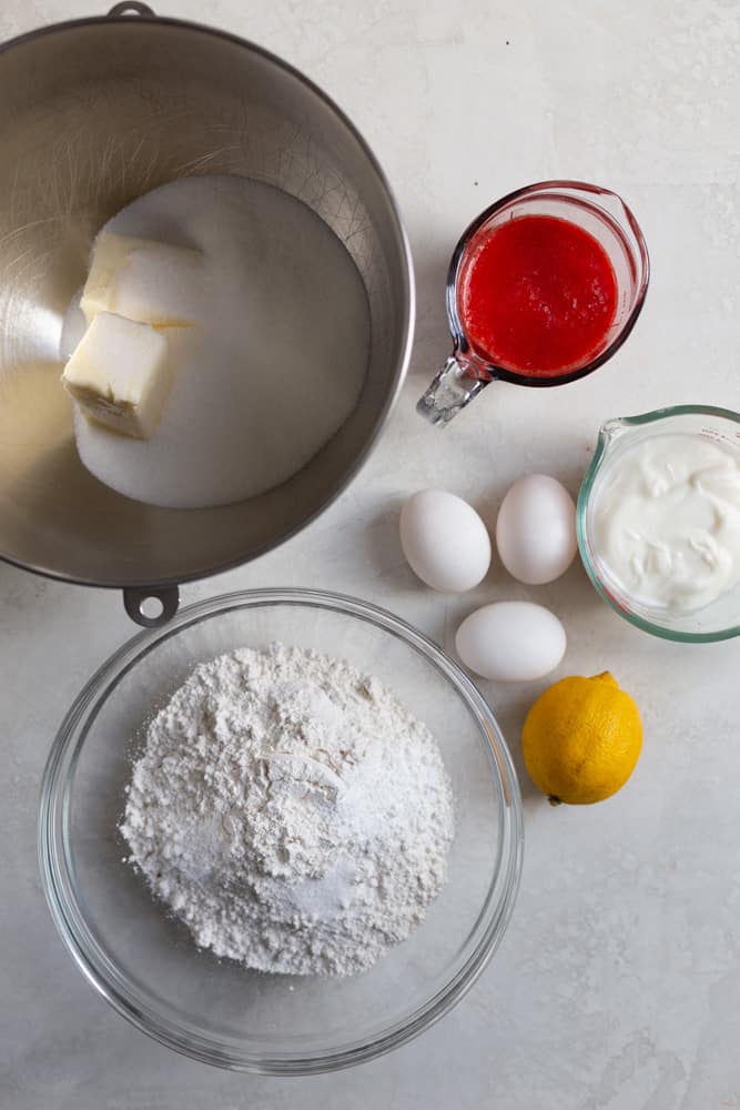 Ingredients for a strawberry bundt cake on a gray background.