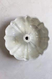 a heavily greased bundt pan on a light gray surface