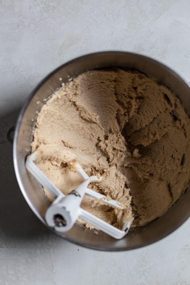 Sugar cookie batter in a mixing bowl on a gray surface