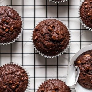 Chocolate banana muffins on a black wire rack