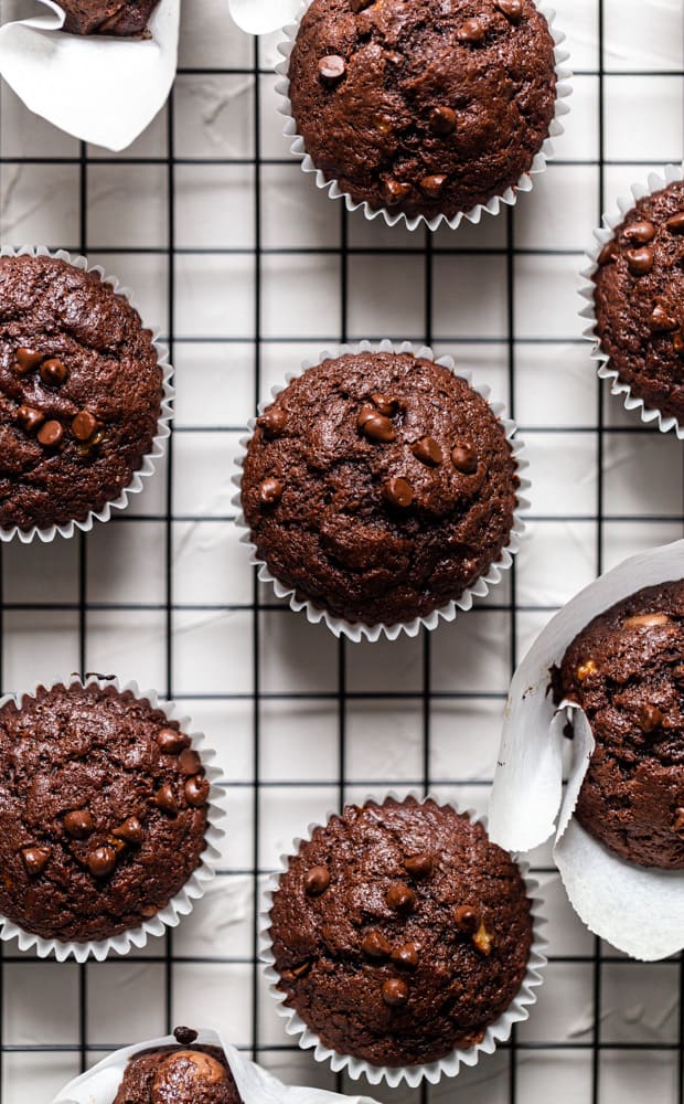 Chocolate banana muffins on a black wire rack