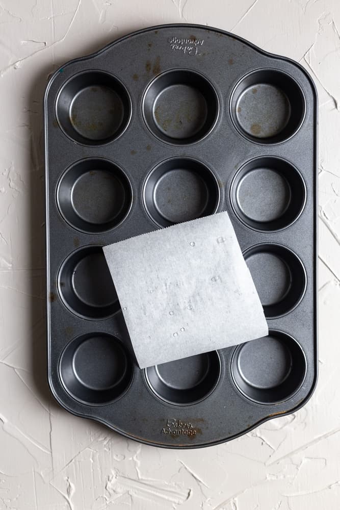 A parchment square on a muffin tin