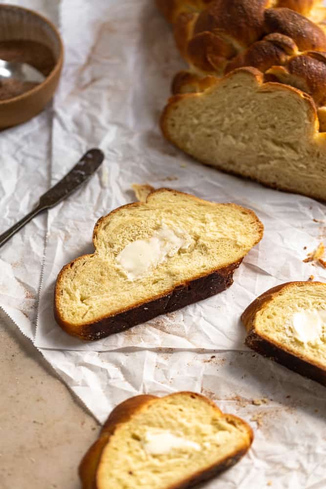 Challah slice with butter slathered on top
