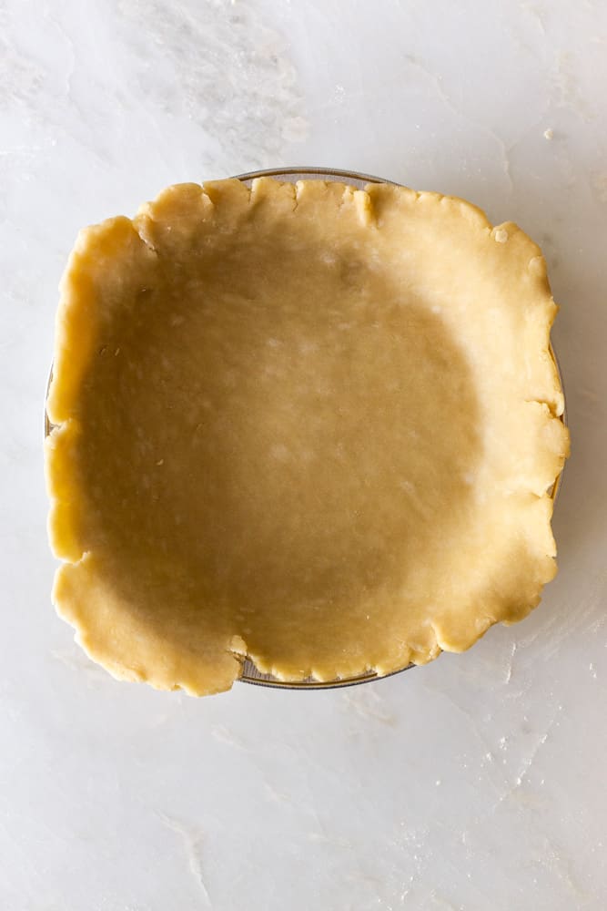 untrimmed pie crust in a tin pan