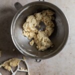 Pie dough crumbles in a metal bowl