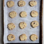 Sliced cookies on a parchment lined baking sheet