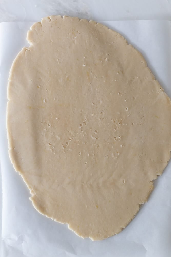 Shortbread dough rolled out onto a white surface