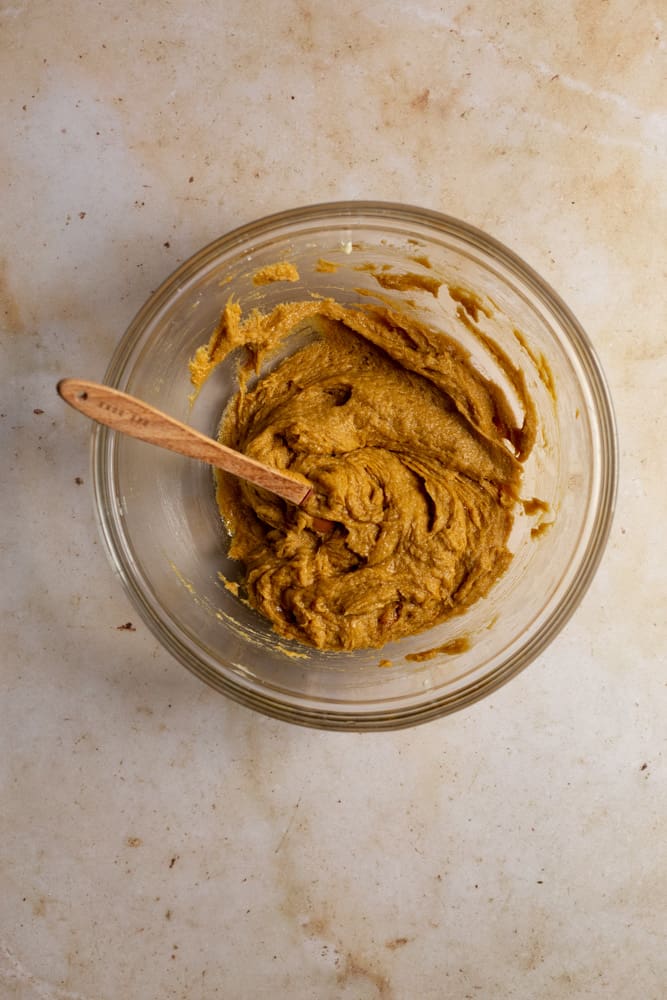 Half of gingersnap batter in a glass bowl