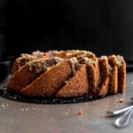 two cut slices of carrot bundt cake peeking out of the whole cake