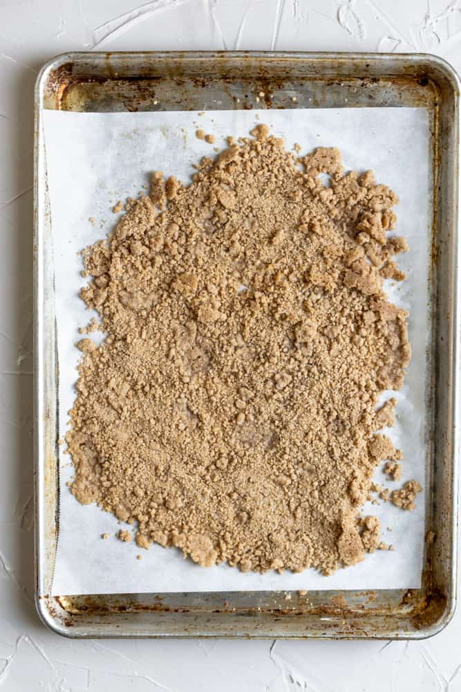 Baked streusel on a parchment paper lined sheet tray