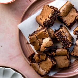 Brownies stacked on a pink plate