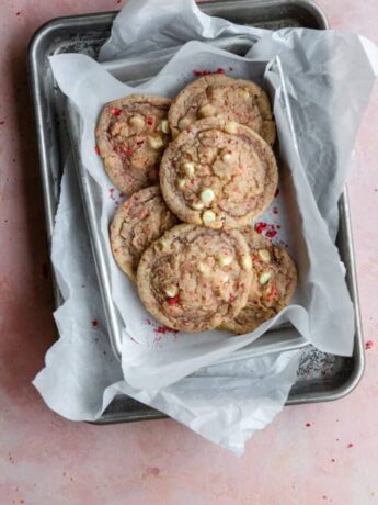 Strawberry cookies layered on baking sheets and parchment paper