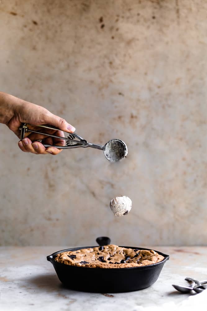 Ice cream dropping onto a skillet cookie