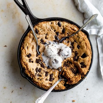Skillet cookie with 3 spoons digging into it